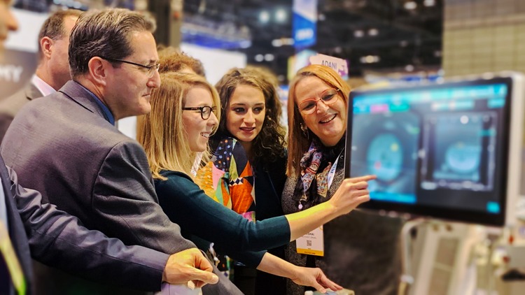 Healthcare technology demonstration with colleagues at a tradeshow